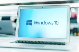 Laptop computer displaying logo of Windows 10, a graphical operating system, developed, marketed and sold by Microsoft
