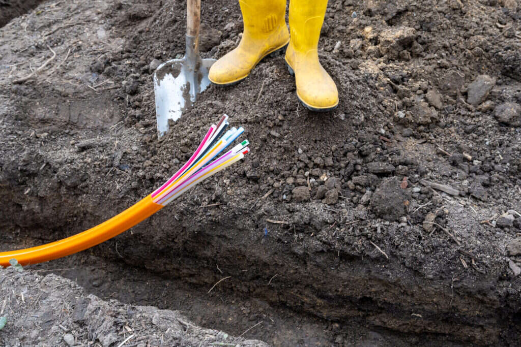 Future of the internet will be fibre optic. In the picture, a fibre-optic wire is coming out fo the ground. 