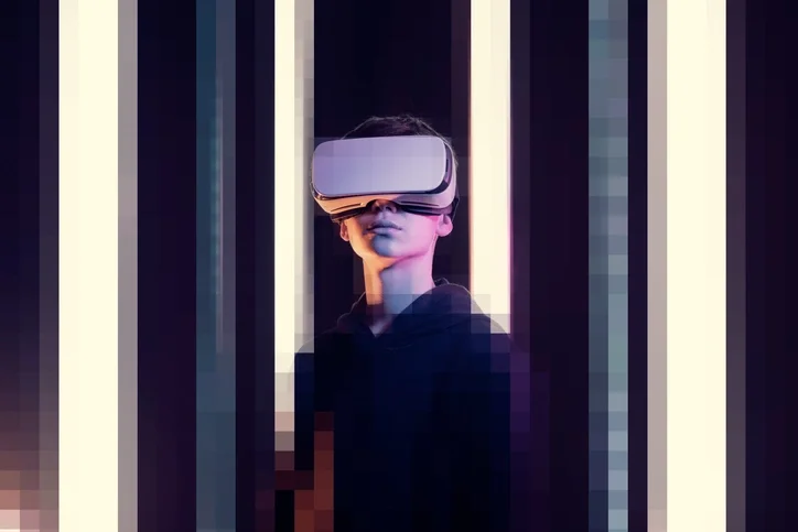 A woman wears a virtual reality headset against a pixelated background. 