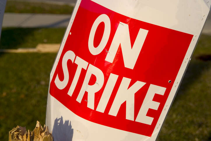 BT workers strike: Image shows a "On Strike" placard sits in garbage pail post strike. Narrow depth with soft background. Shot in sun setting light.
