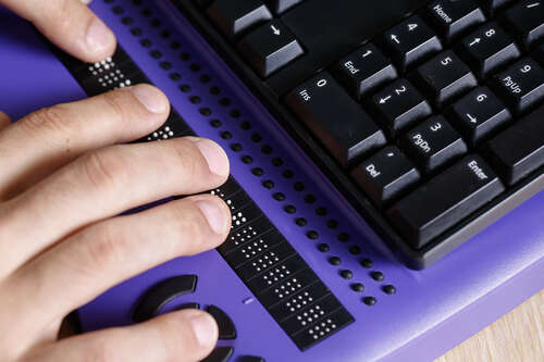 Accessibility keyboard used by a blind person. 