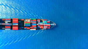 A photo of a container ship at sea, used to illustrate a story about the sector's embrace of generative AI.