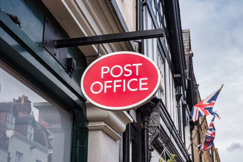 Post Office sign outside a building