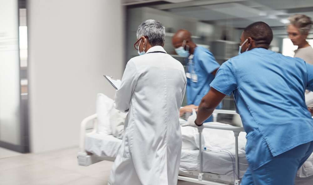 Medical staff rush a patient through the hospital
