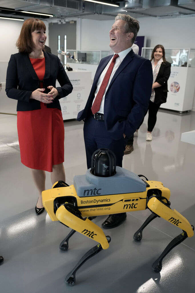 Rachel Reeves and Sir Keir Starmer share a joke while a yellow robotic dog waits, ominously, at their feet.