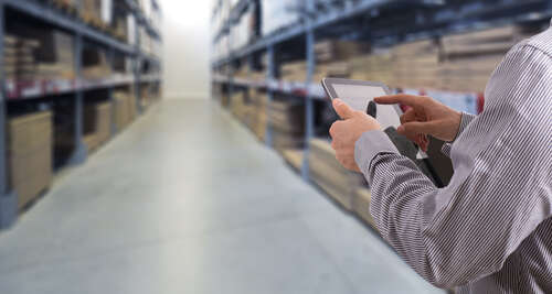 Man managing warehouse with technology - digital distributors