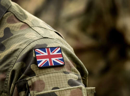 An image of a Union Jack patch on the shoulder of a armed forces uniform. 