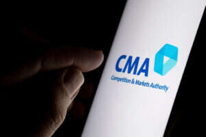 A smartphone has "CMA" and its logo on its screen.