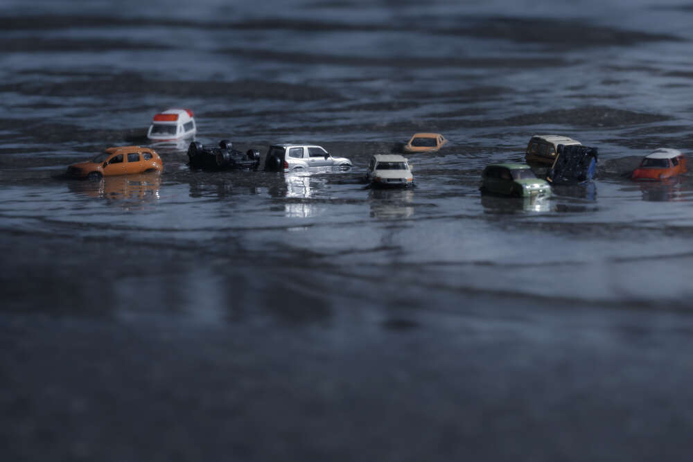 A depiction of cars washed out to sea, a visual metaphor for the role of quantum computing in weather forecasting. 