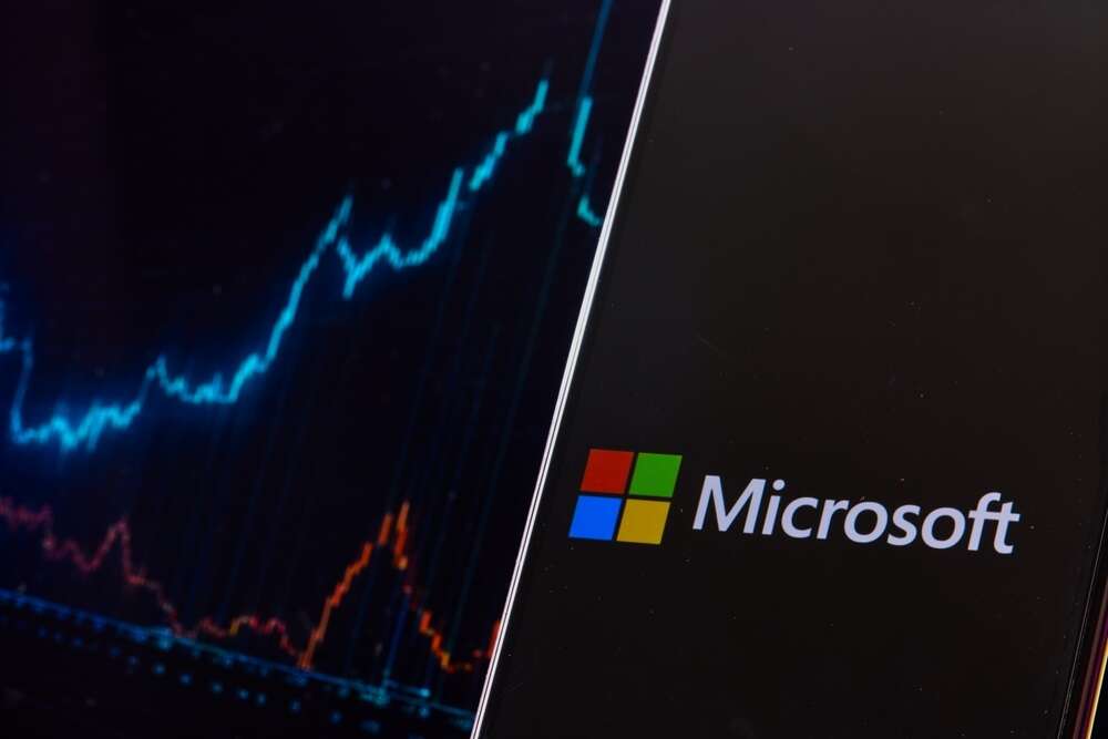 The Microsoft logo in front of a line chart.