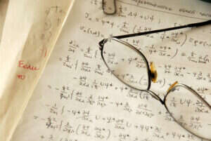 A pair of glasses on an exercise book.