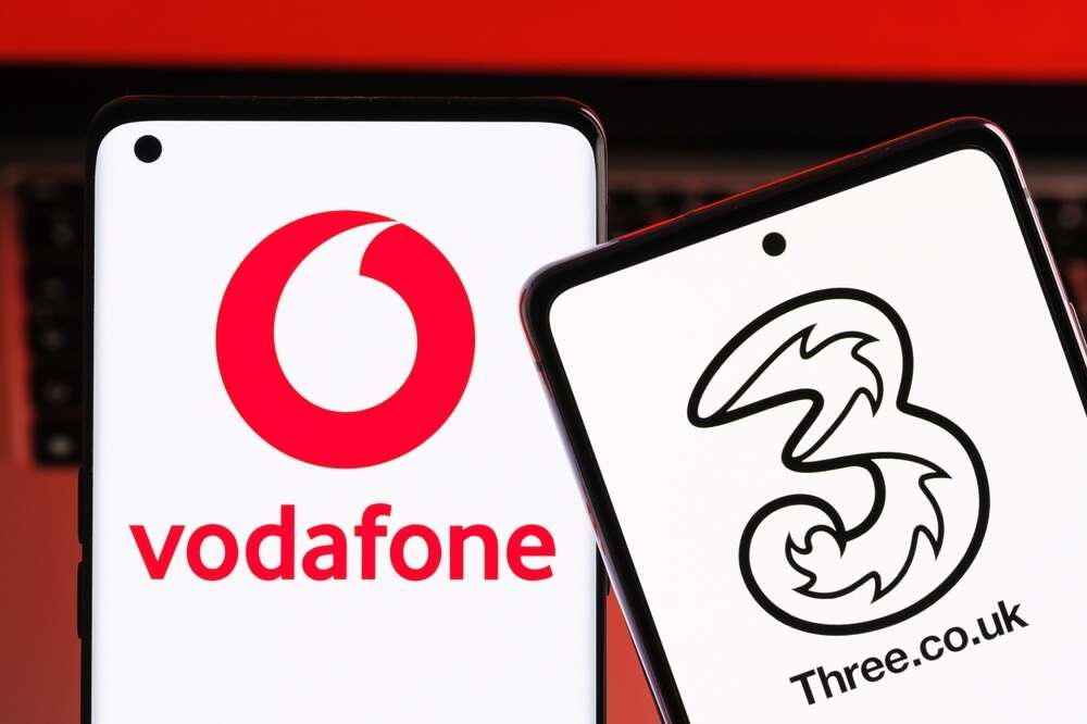The logos of Vodafone and Three on mobile phones, used to illustrate a story about a CMA probe into the proposed Vodafone Three merger.